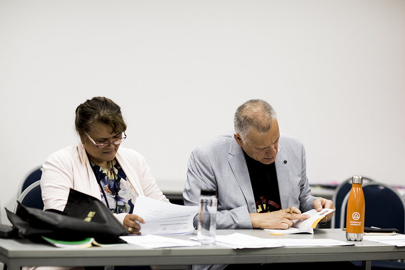 Kairuruku social work Jodie Owen and Papaiōea kaiako Lewis Stephens assess one of the presentations