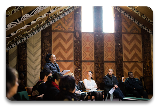 A person sharing their mihi inside a marae for their tikanga course