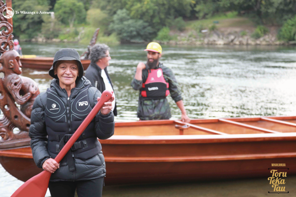 Amiria O’Malley with Te Rau o Te Aroha and Kaihautu Hoturoa Kerr-Barclay and Turanga Kerr-Barclay in the background.