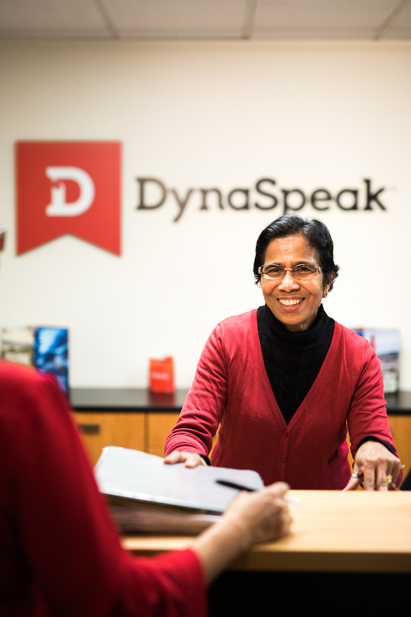 The kaimahi at DynaSpeak office reception helps a student enrol