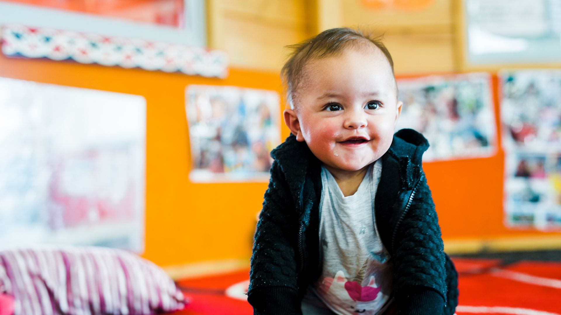 Toddler smiling while in class