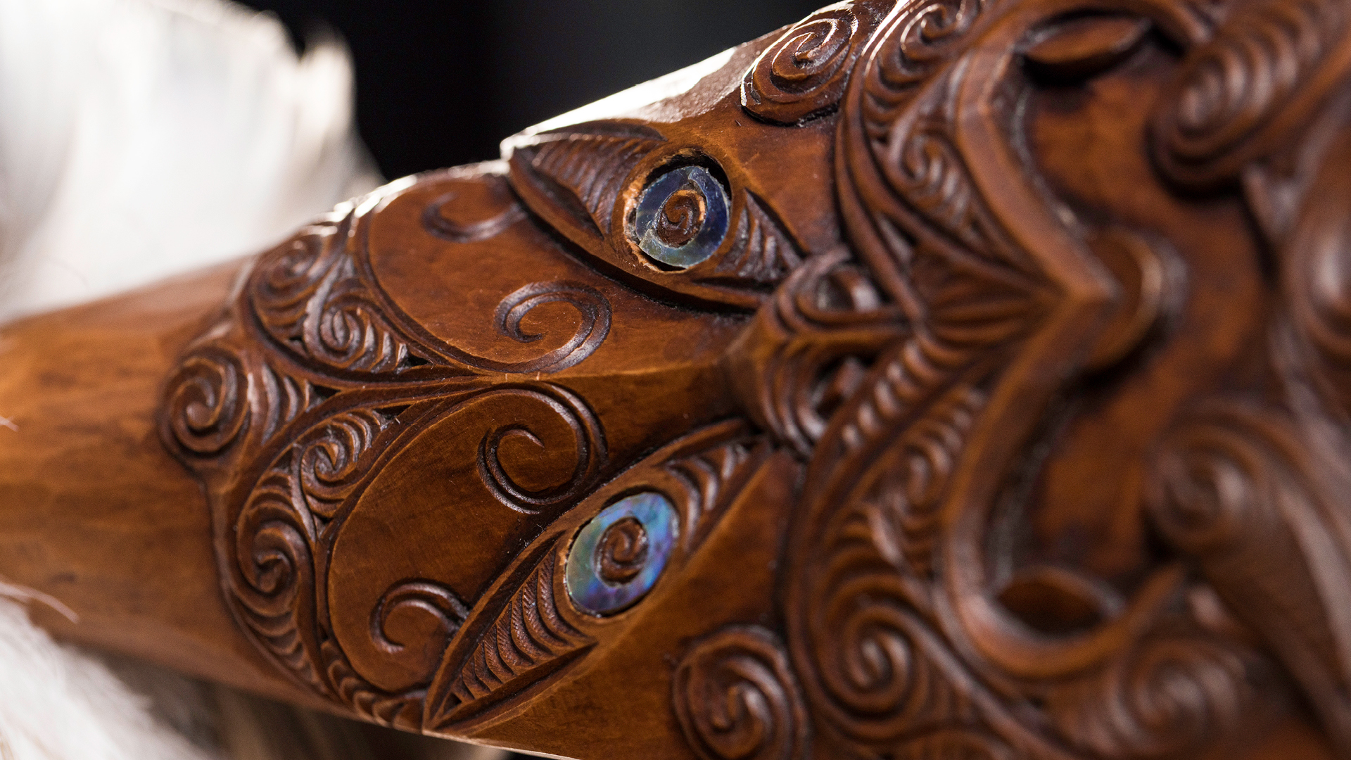 Te Wānanga o Aotearoa_Te Tirohanga Māori. Close up of Māori carving on long piece of wood. 