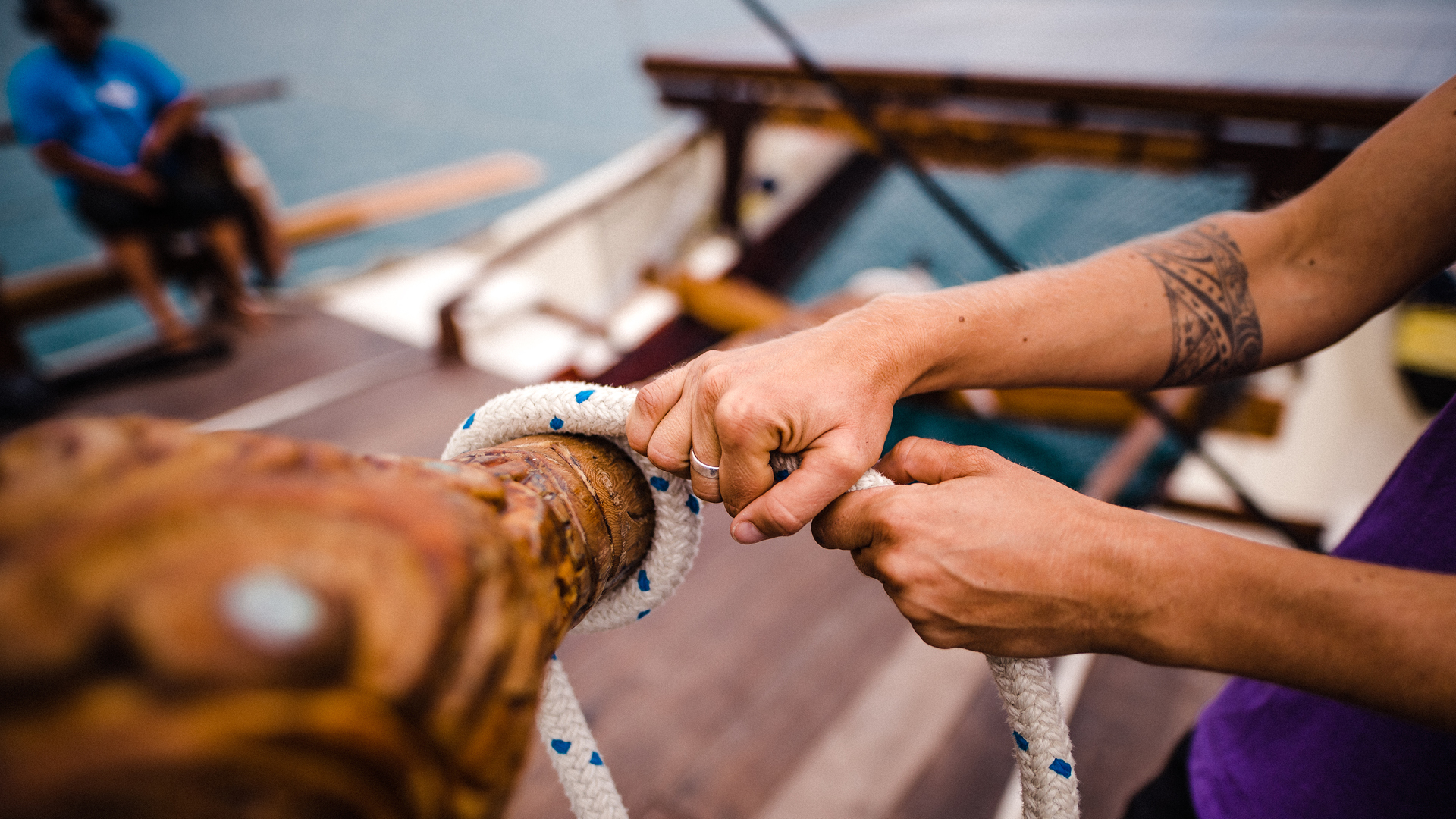 Waka with hands pulling on rope