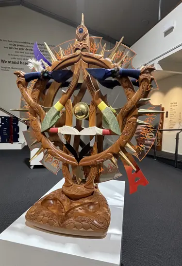 Artist: Kereti Rautangata. Iwi: Waikato, Ngaati Mahanga, Ngaati Tipa, Ngaati Koroki, Ngaati Maniapoto, Ngaati Pikiao, Ngaati Puukenga. Artwork: Te Hahunga o te Rangahau 2011. Material: Kauri, stainless steele, brass, Whale Bone, Crystal, Aluminium, Paua, Feathers, String Binding, Alloy(frame Inset), Laquer, Custom Board, L.E.D Lighting 