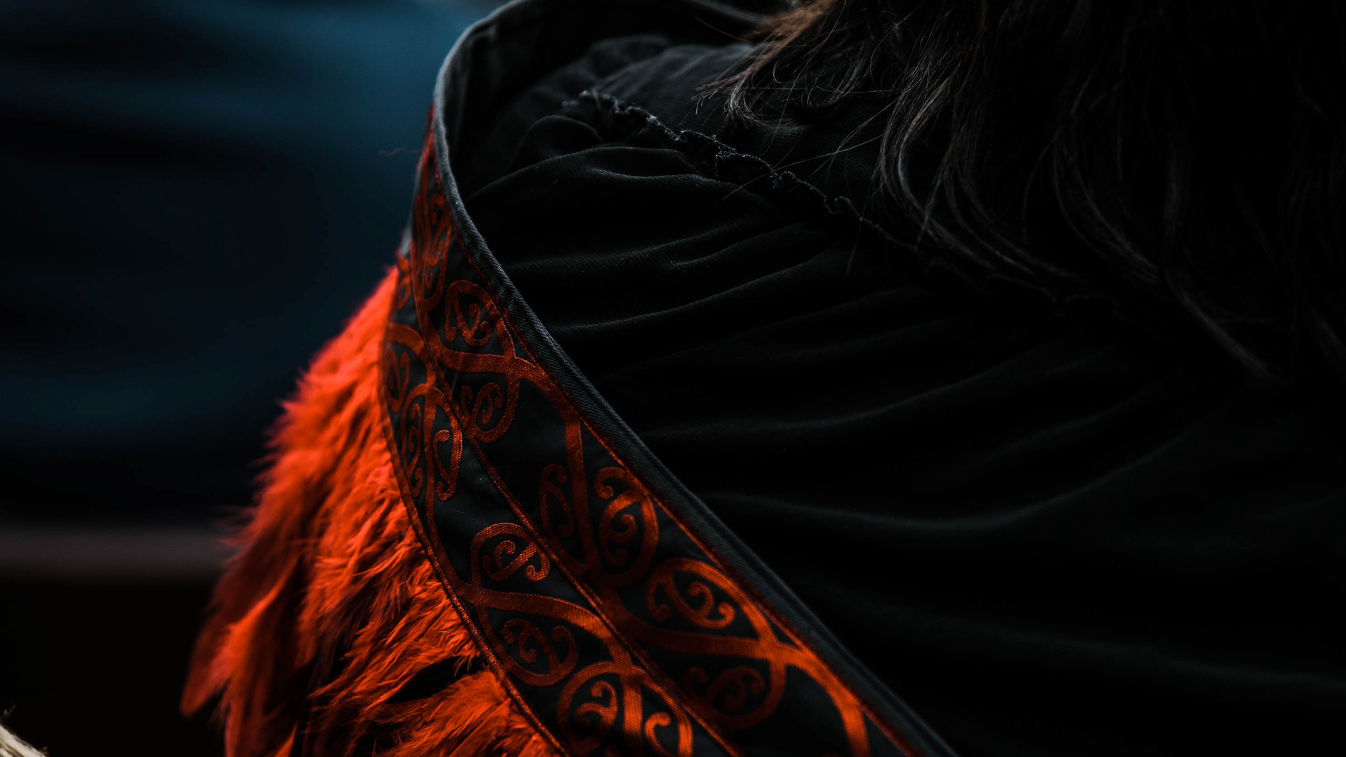 Close up of a red and black korowai