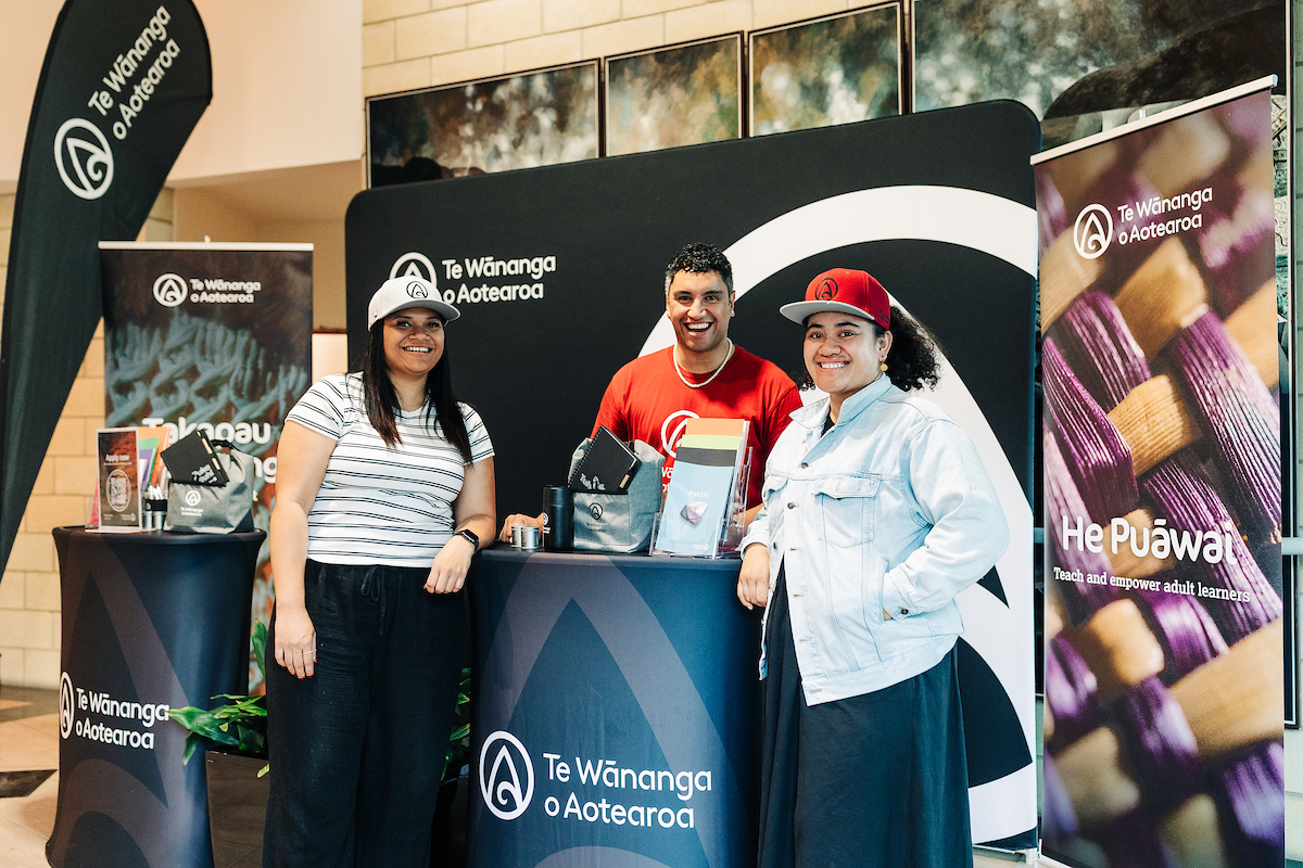Te Wānanga o Aotearoa kaimahi supporting potential students at an event booth