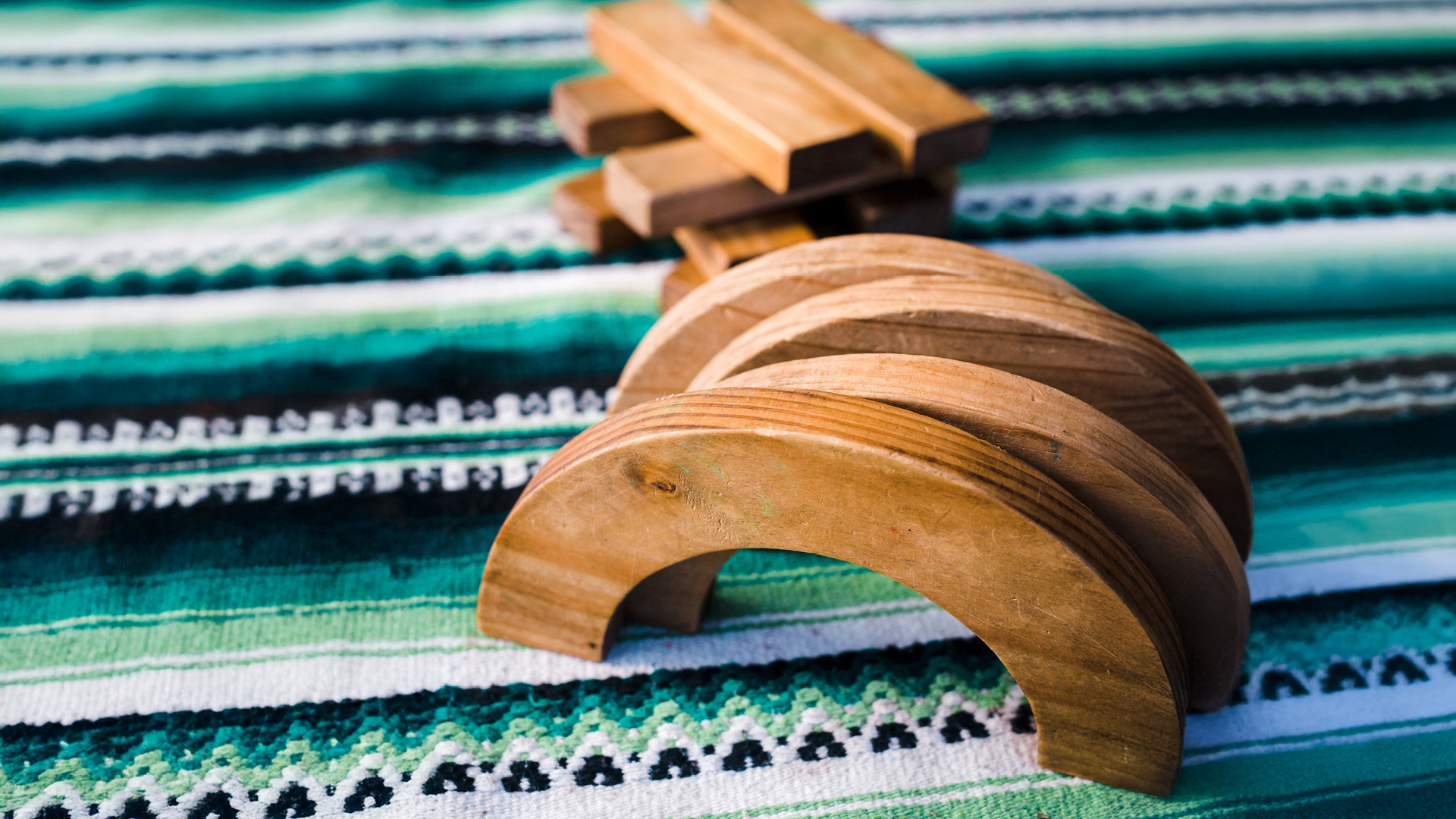 Wooden play blocks on mat