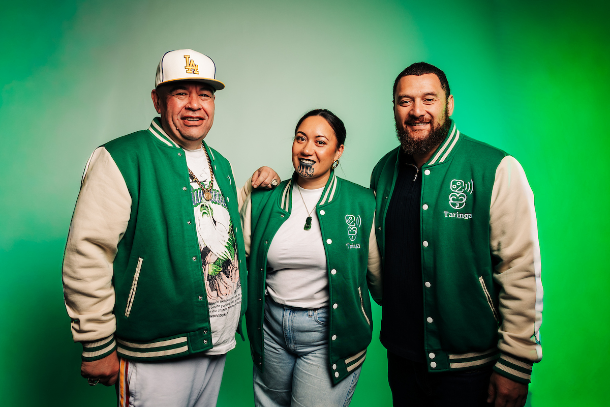 The Taringa podcast hosts wearing matching green jackets