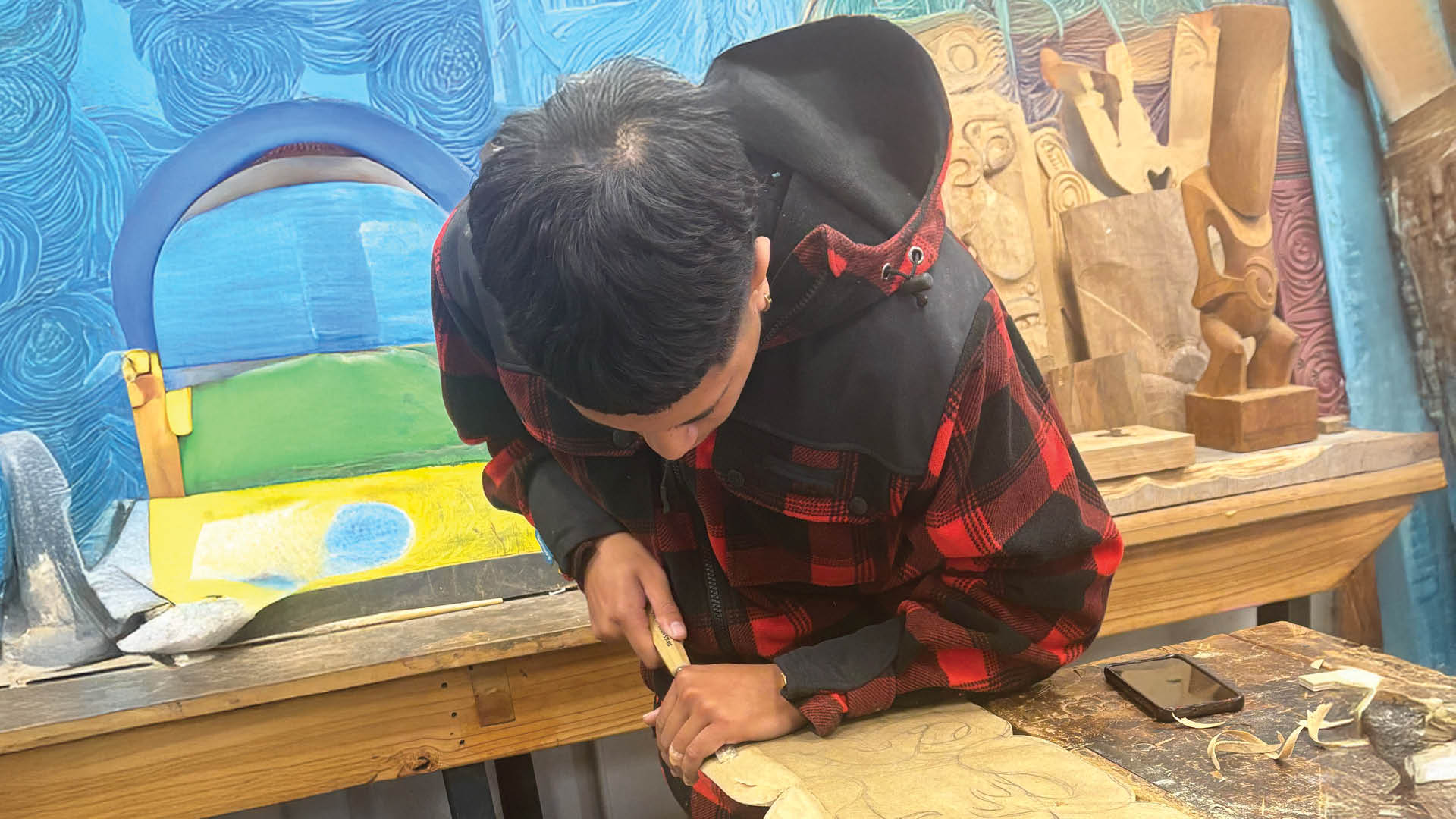Te Wānanga o Aotearoa_He Aranga Taiohi_Youth_Hei Tikitiki. Visually represented by a young man carving a wooden artwork.