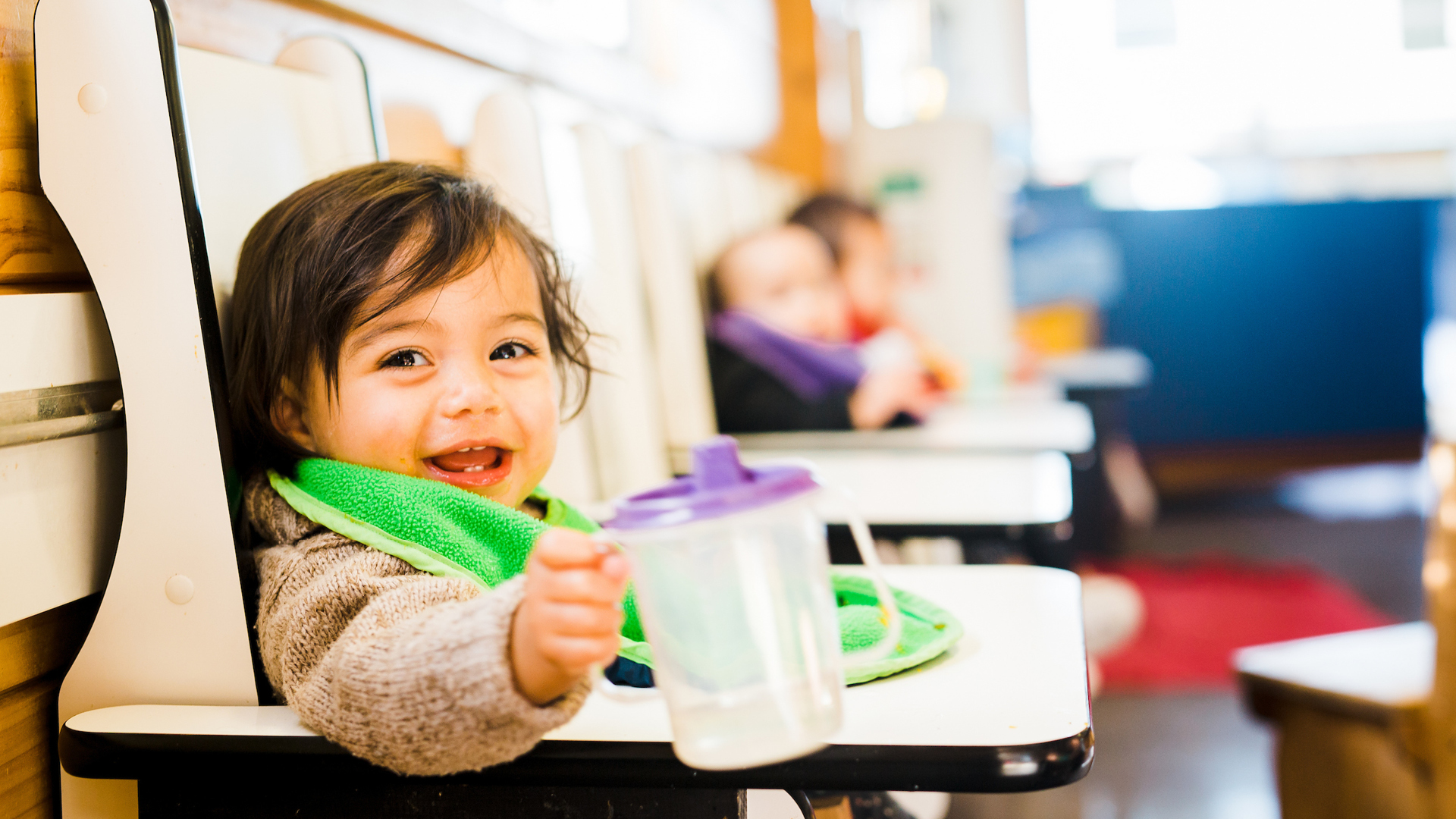 Happy child in highchair at meal time