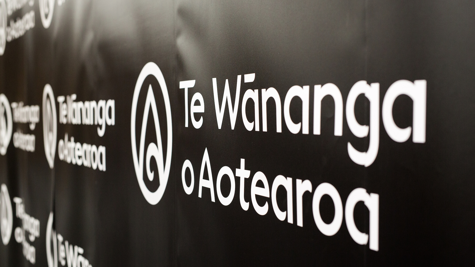 Te Wānanga o Aotearoa branded logo wall at an event