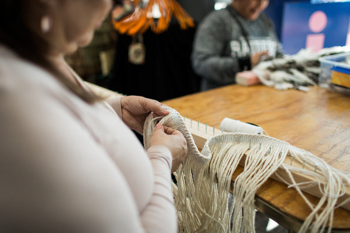 A raranga student weaving in class