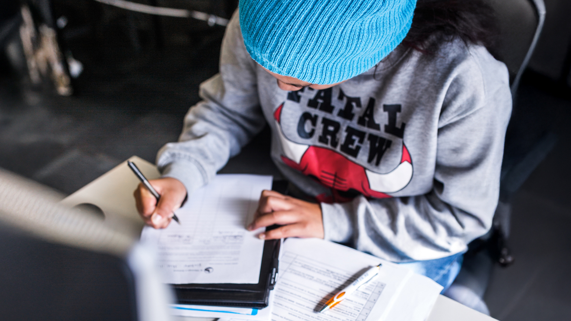 A student writes in document