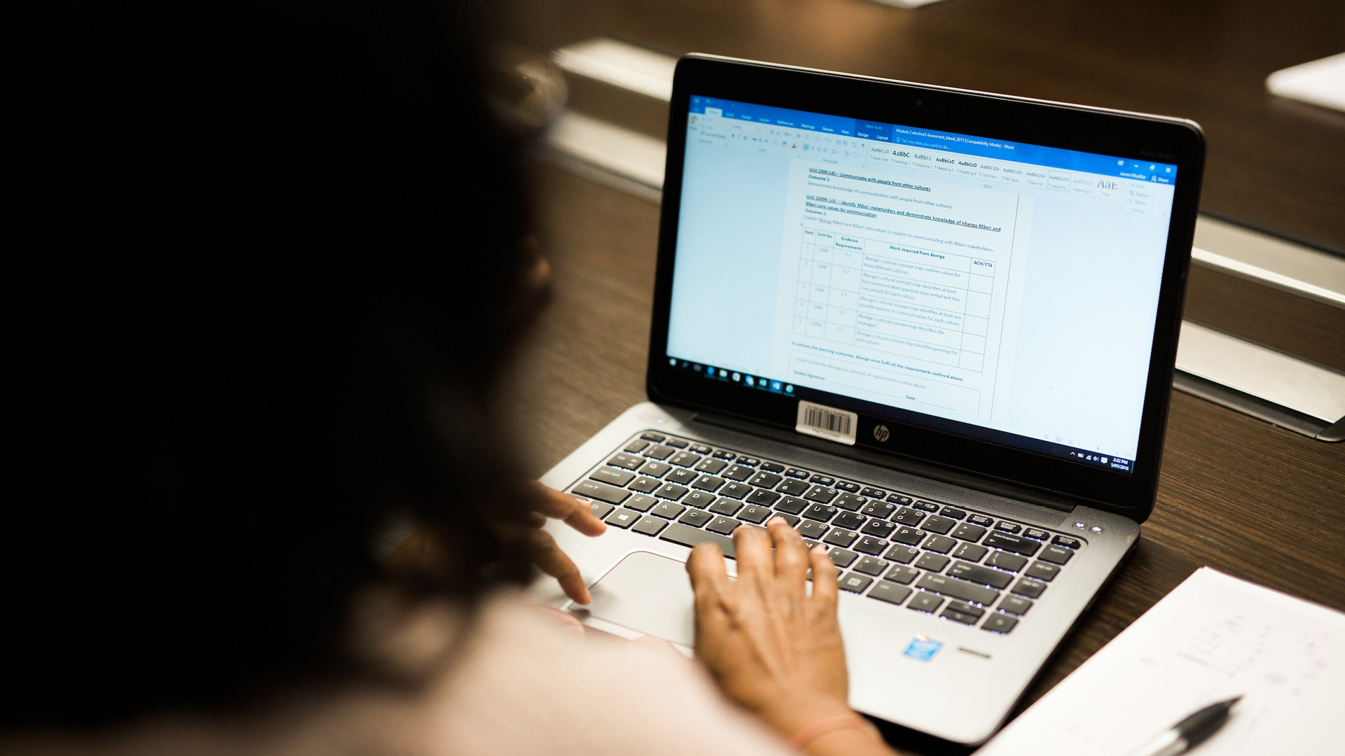 A person writing on their laptop
